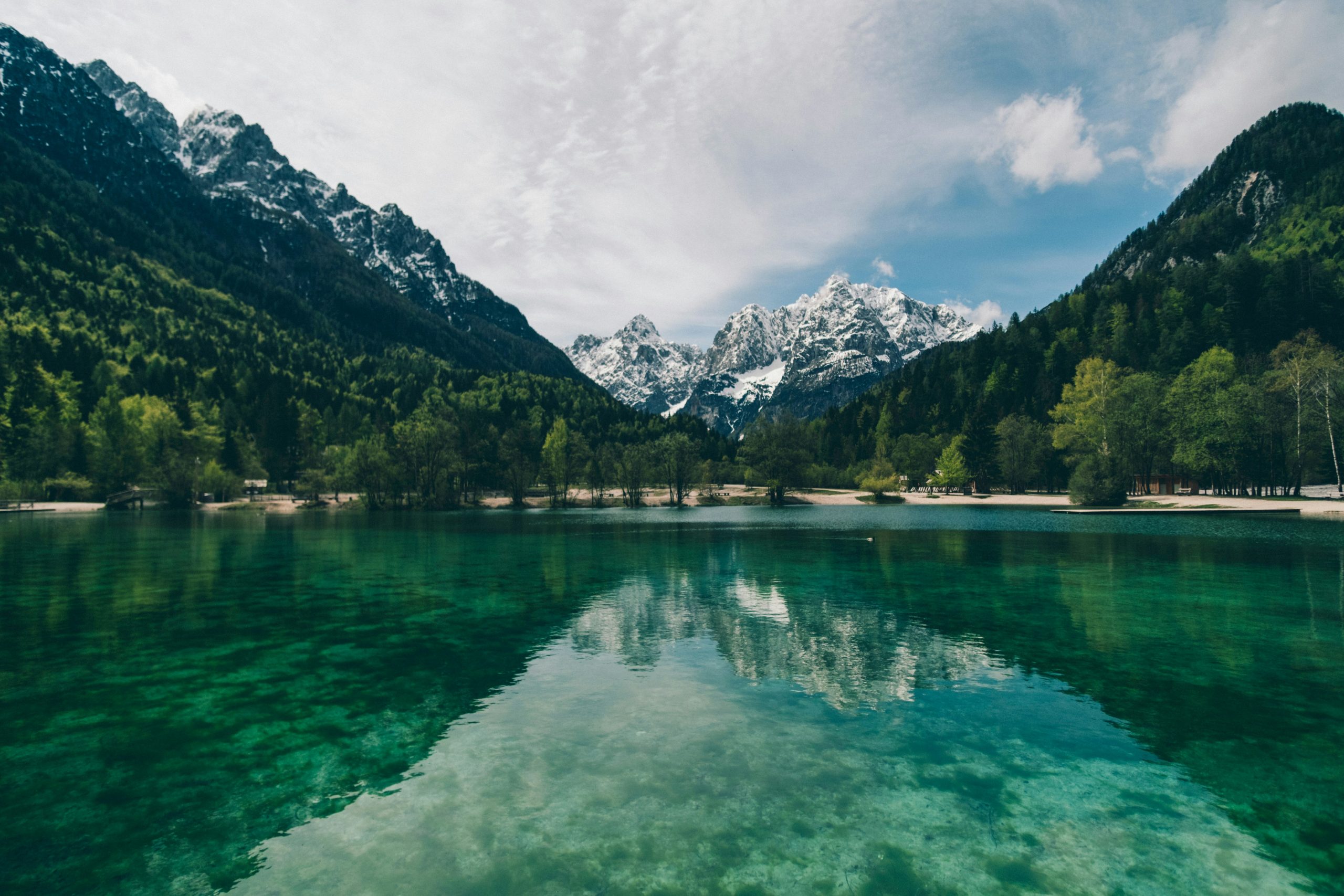 A lake with snow-capped mountains in the background, Adam Vradenburg